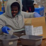 VOLUNTEER: Skill Building Program participant counting supplies during his shift.